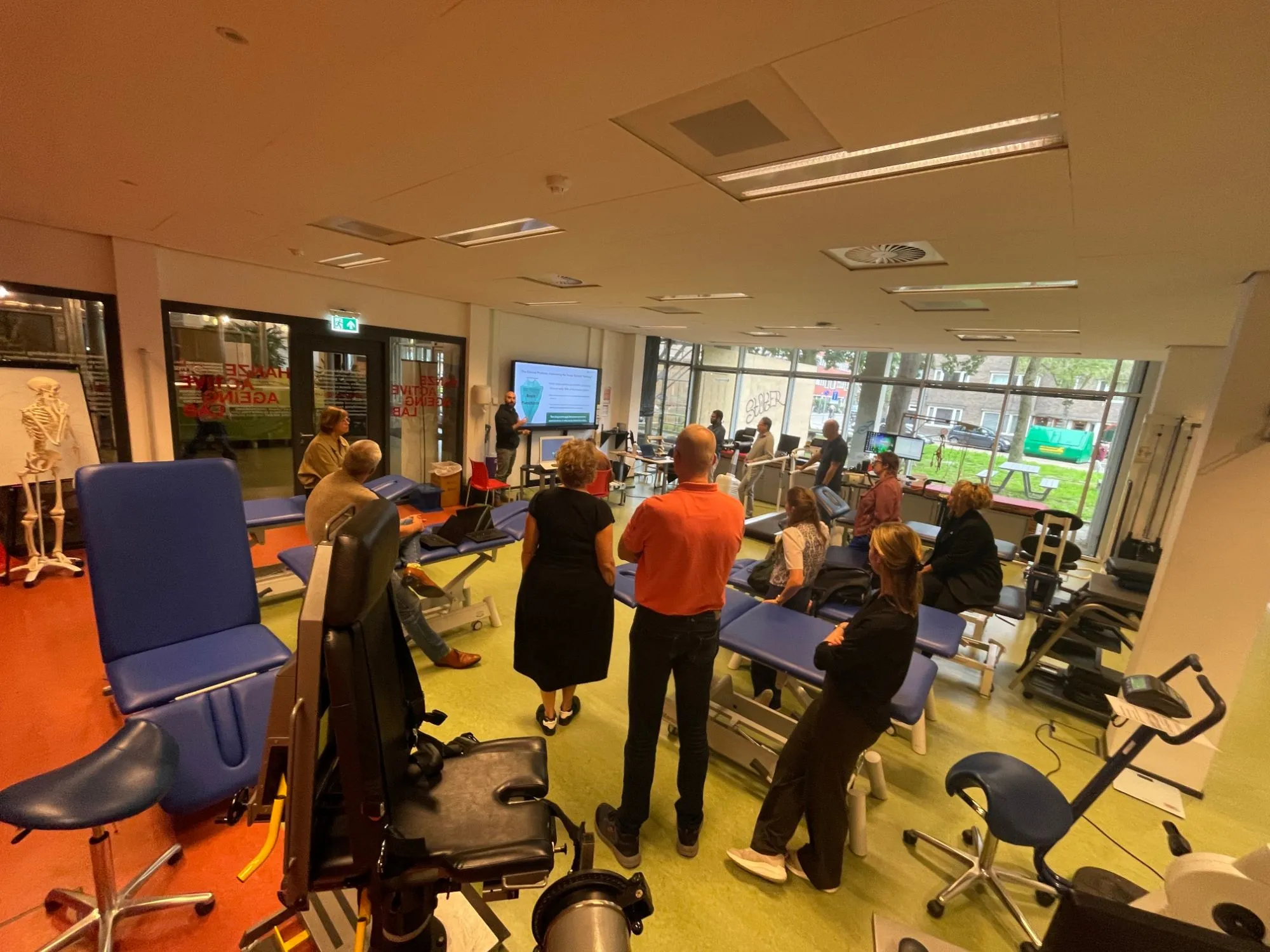 Participants of the Sensory-Motor Network meetup listening to a presentation in the lab